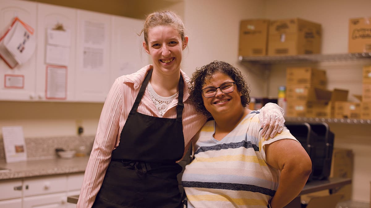 Two girls smiling for photo.